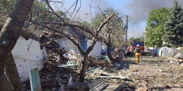 Officials on the scene after a Russian missile struck a train station in Ukraine. 