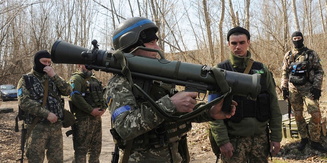 FILE - Ukrainian servicemen study a Sweden shoulder-launched weapon system Carl Gustaf M4 during a training session on the near Kharkiv, Ukraine, April 7, 2022. 