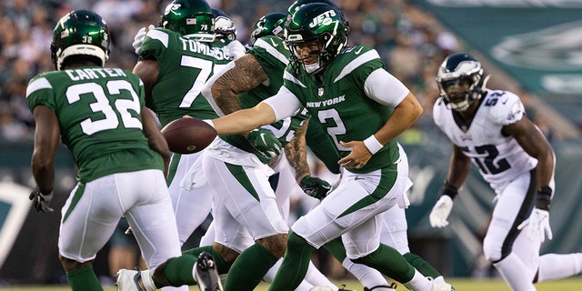 New York Jets quarterback Zach Wilson (2) fakes a handoff to running back Michael Carter (32) during the first quarter against the Philadelphia Eagles at Lincoln Financial Field in Philadelphia, Pennsylvania, on Aug. 12, 2022.