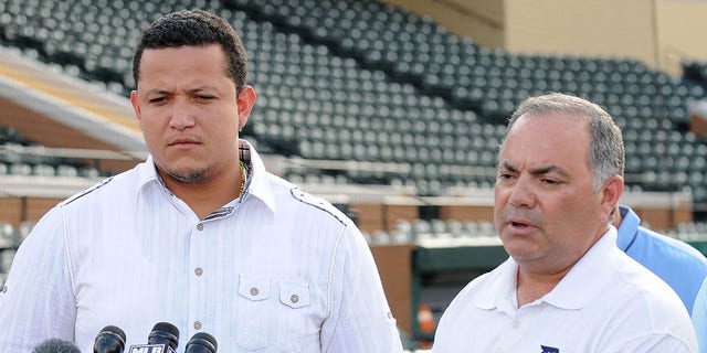 Miguel Cabrera, left, of the Detroit Tigers looks on as Tigers Vice President and Assistant General Manager Al Avila speaks to the media during a press conference at spring training on Feb. 24, 2011, in Lakeland, Florida.