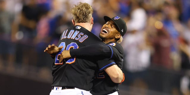 Pete Alonso #20 of the New York Mets celebrates with Francisco Lindor #12 and Brett Baty #22 after hitting a walk-off single in the bottom of the ninth inning to defeat the Colorado Rockies 7-6 at Citi Field on August 26, 2022 in New York City.