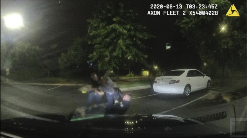 Dash cam still of Officers Garret Rolfe and Devin Bosnan struggling with Rayshard Brooks.