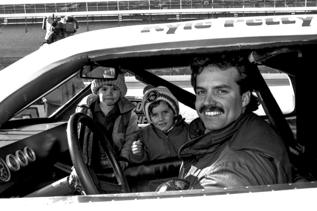 Kyle Petty grew up with a father and grandfather who were racing superstars and joined them at age 18. He in turn handed down that legacy to his own kids, Austin and Adam (here, with Kyle at Charlotte Motor Speedway in 1985).