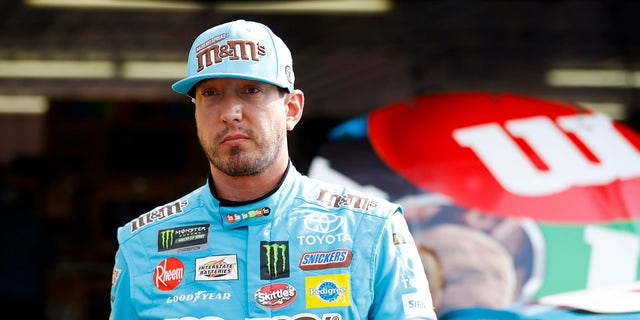 Kyle Busch walks from the garage area after a practice session for the NASCAR Cup Series race at Pocono Raceway May 31, 2019, in Long Pond, Pa. 