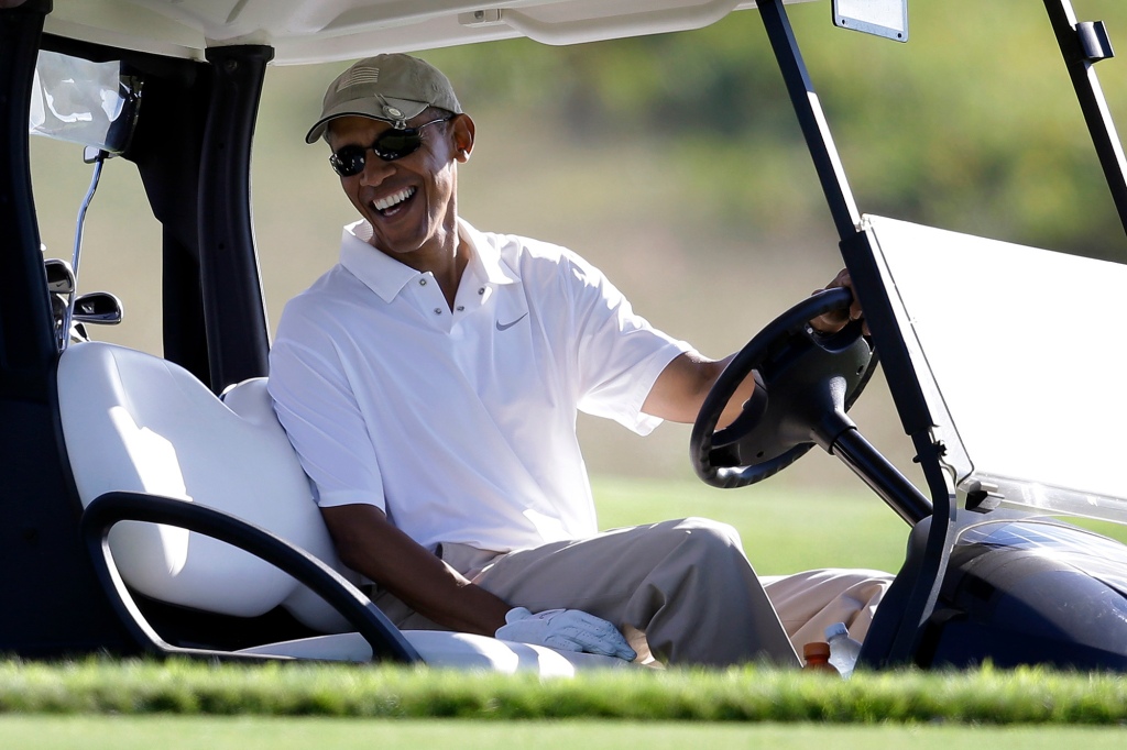 Former President Obama sitting in a golf cart while playing golf at Vineyard Golf Club in Edgartown, Massachusetts 