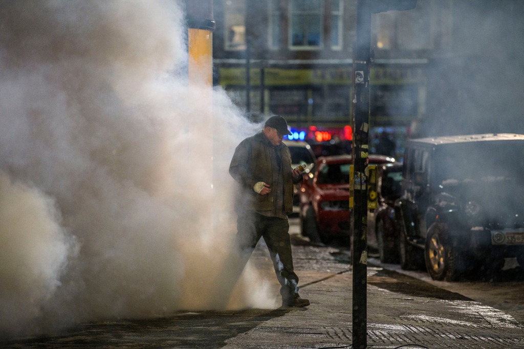 Brendan Fraser is seen filming on the streets of Glasgow City Centre, which is doubling up as Gotham City. He is walking out of a burning pharmacy clutching a bottle of pills.