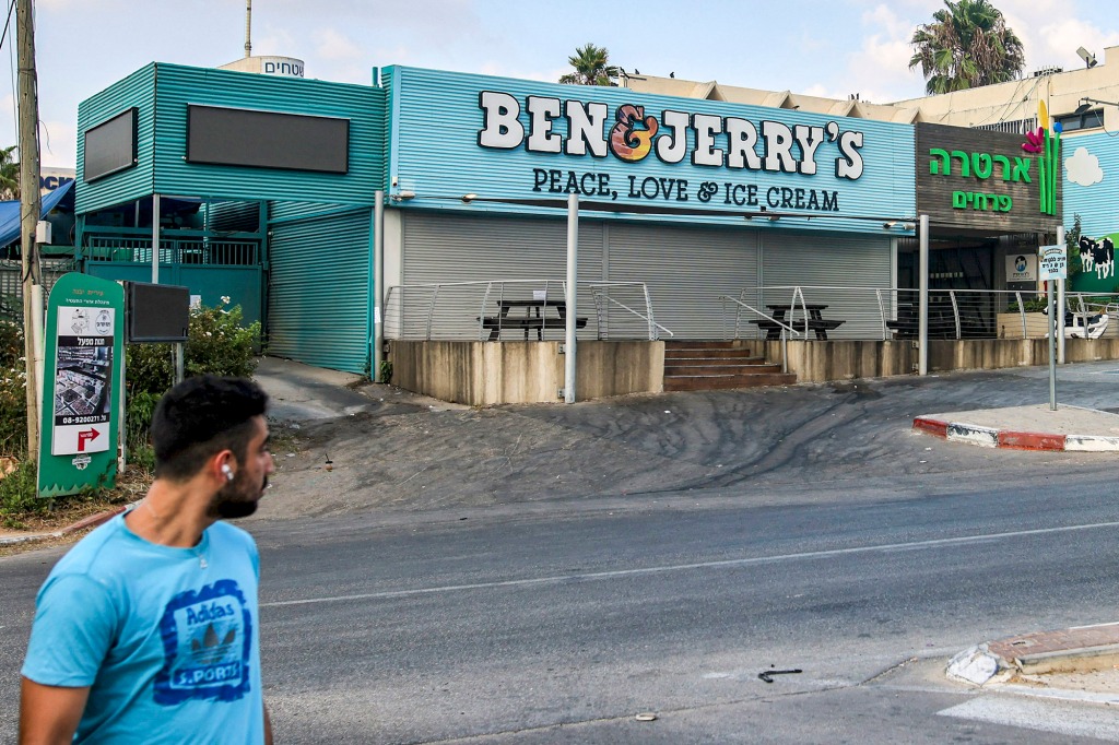 A man looks back at a closed Ben & Jerry's shop in Israel.