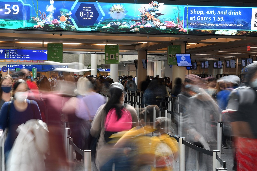 ORLANDO, FLORIDA, UNITED STATES - 2021/11/24: Travelers wait in a long queue at the security checkpoint of Orlando International Airport the day before the Thanksgiving holiday.
