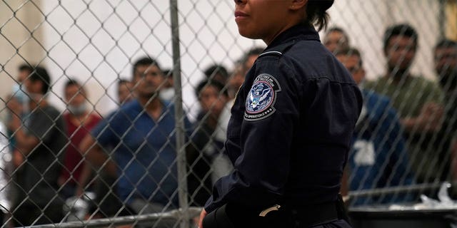 A U.S. Customs and Border Protection agent monitors single-adult male detainees at Border Patrol station in McAllen, Texas, U.S. July 12, 2019.  