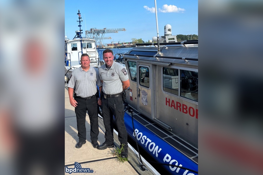 The Boston Police officers rescued the two men about 100 yards off the coast of Graves Light in the Boston Harbor.