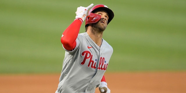 The Philadelphia Phillies' Bryce Harper celebrates after his two-run home run during the first inning against the Washington Nationals Aug. 30, 2021, in Washington.