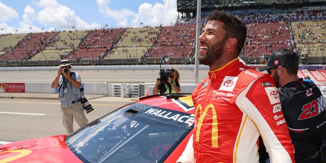 Bubba Wallace, driver of the No. 23 McDonald's Toyota, celebrates after winning the pole for the NASCAR Cup Series FireKeepers Casino 400 at Michigan International Speedway Aug. 6, 2022, in Brooklyn, Mich.