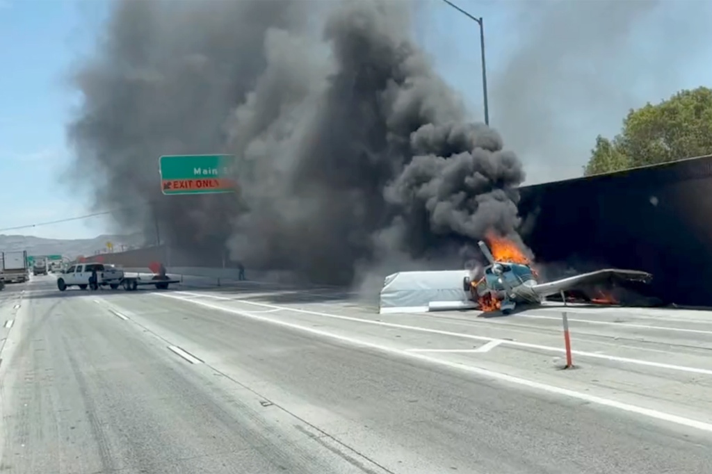 A small plane is engulfed in flames after it crashed on a California freeway Tuesday.