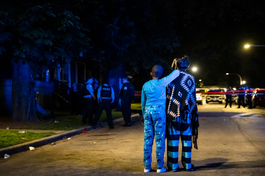 Family members watch as Chicago police investigate a fatal shooting. Chicago is typical of many big US cities — most violent crime takes place in just a handful of neighborhoods. 