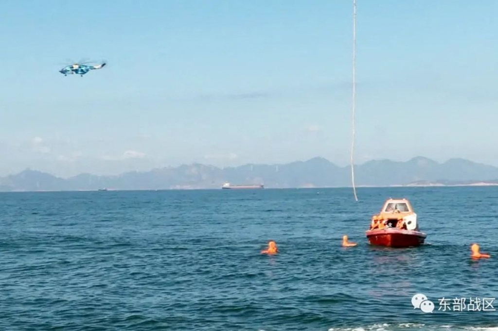 A Chinese helicopter and boat participating in a maritime rescue drill in the waters around Taiwan on August 9, 2022.