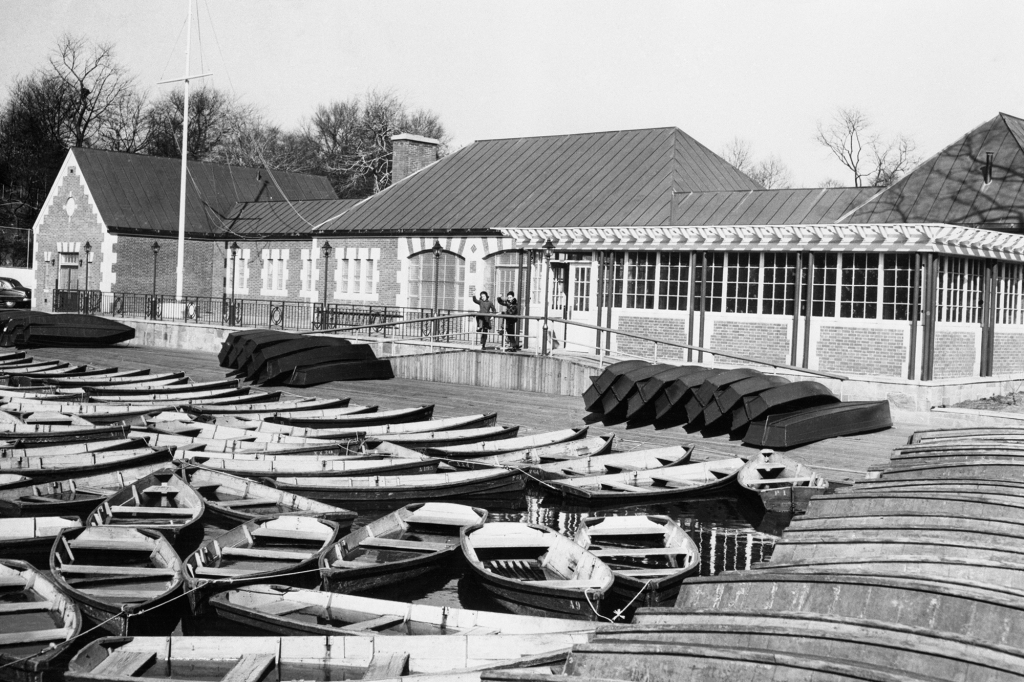 These empty rowboats are ready for the early Spring Trade at the new boathouse at Central Park's lake. Located at the 72nd St. Lake and East Drive, the boathouse is a gift of Adeline and Carl M. Loeb. Young early birds (center) are counting the days.