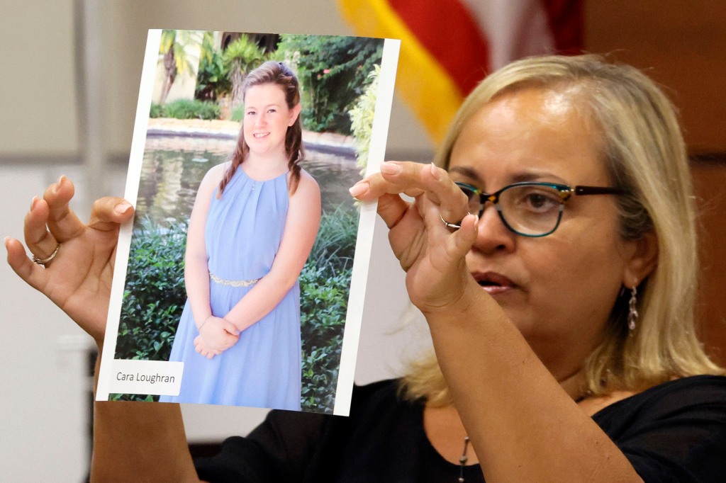 holding up a photo of Parkland victim Cara Loughran while on the stand.