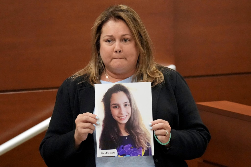 Jennifer Montalto holding a photo of her daughter Gina while giving her victim impact statement.