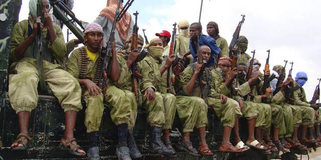 In this Oct. 30, 2009 file photo, al-Shabab fighters sit on a truck as they patrol in Mogadishu, Somalia. (AP Photo/Mohamed Sheikh Nor)