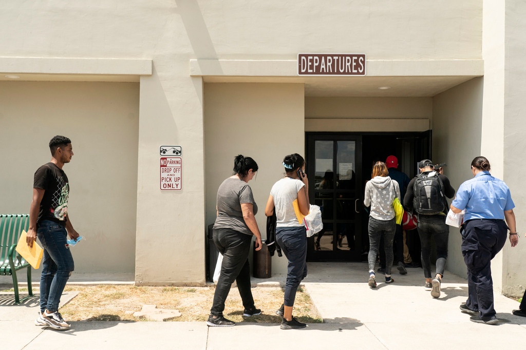 Migrants, mostly from Venezuela and Cuba, enter the terminal building at Del Rio International Airport to take flights to their final destinations such as Colorado and Florida,  in Del Rio, Texas on August 12, 2022.