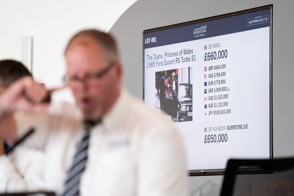 Auctioneer Jonathan Humbert takes bids for the 1985 Ford Escort RS Turbo previously owned by Diana, Princess of Wales, under the hammer at Silverstone Classics at the Silverstone Race Circuit near Towcester, Northamptonshire, and which sold for £650,000. Picture date: Saturday August 27, 2022. (Photo by Joe Giddens/PA Images via Getty Images)