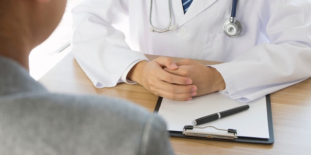 Doctor and patient sitting together. 