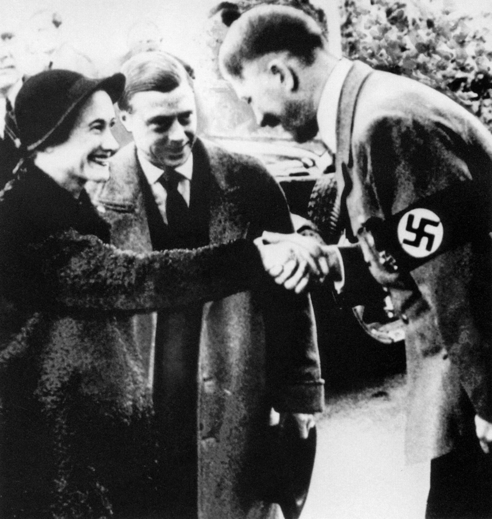 The duke and duchess of Windsor are greeted by Adolf Hitler in 1937.