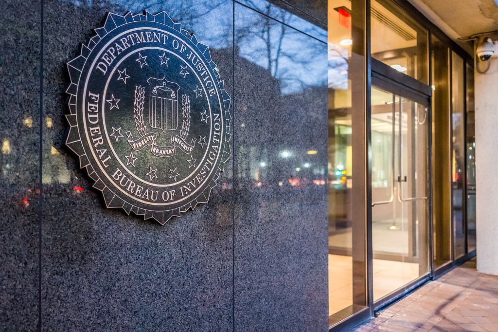 Washington Dc, United States - December 29, 2016: FBI, Federal Bureau of Investigation Headquarters, on Pennsylvania avenue sign with traffic reflections at night