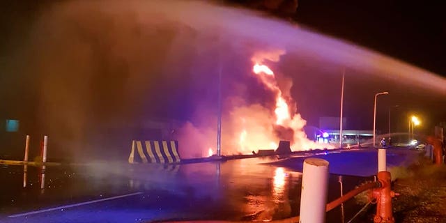 In this photo provided by the Saudi Press Agency, firefighters try to extinguish a blaze at an Aramco terminal in the southern border town of Jizan, Saudi Arabia, March 20, 2022. 