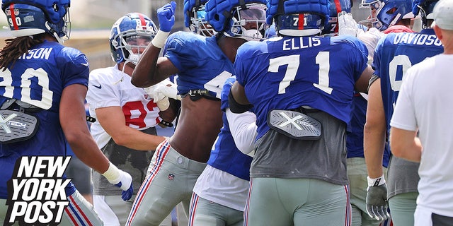 New York Giants linebacker Cam Brown, center, is about to throw a punch during a fight that broke out between the offense and the defense at training camp on Monday, Aug. 8, 2022, at the Giants training facility in East Rutherford, New Jersey.