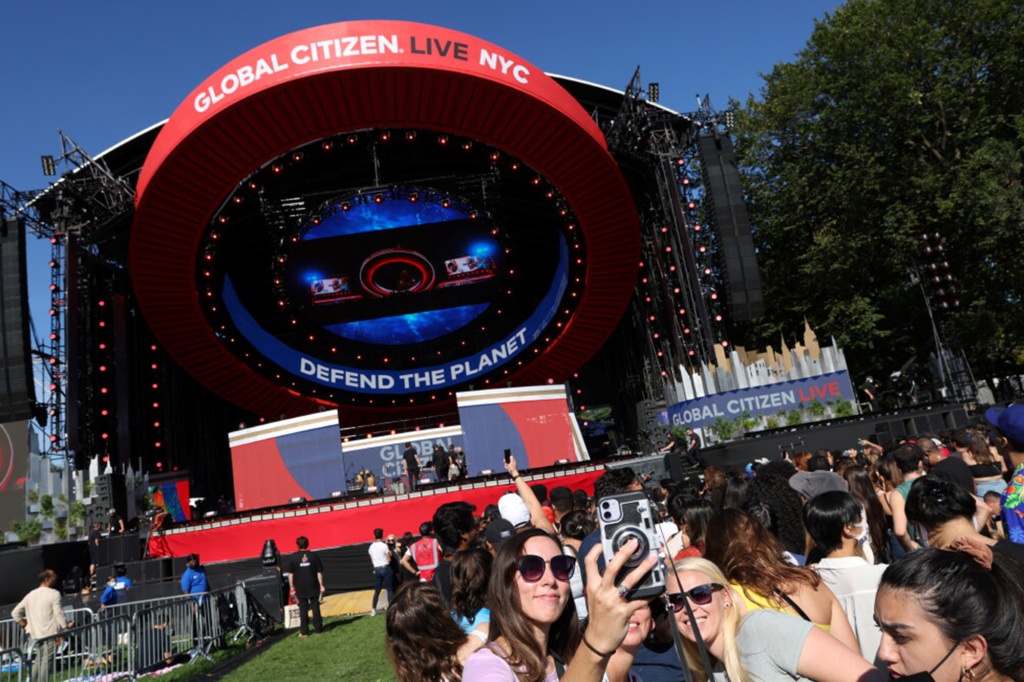 People take a selfie in front of the stage before the 2021 Global Citizen Live concert at Central Park in New York, U.S., September 25, 2021.