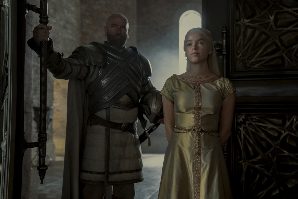 Ser Harrold Westerling (Graham McTavish) with Princess Rhaenyra Targaryen (Milly Alcock) in "House of the Dragon" standing in a doorway. 