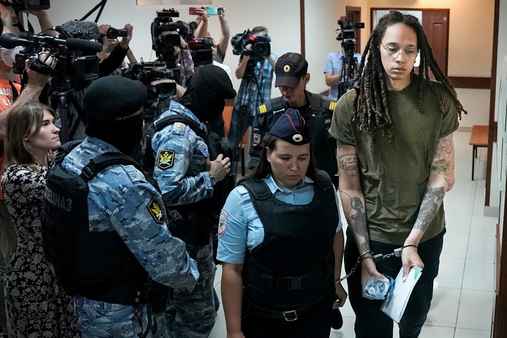 FILE - WNBA star and two-time Olympic gold medalist Brittney Griner is escorted in a court room prior to a hearing, in Khimki just outside Moscow, Russia, Tuesday, Aug. 2, 2022. Closing arguments in Brittney Griner's cannabis possession case in Russia are set for Thursday. That's nearly six months after the American basketball star was arrested at a Moscow airport in a case that has reached the highest levels of U.S.-Russia diplomacy. (AP Photo/Alexander Zemlianichenko, File)