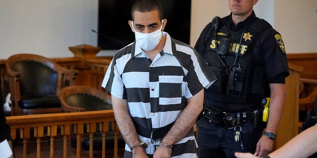 Hadi Matar, 24, center, arrives for an arraignment in the Chautauqua County Courthouse in Mayville, N.Y., Saturday, Aug. 13, 2022. 