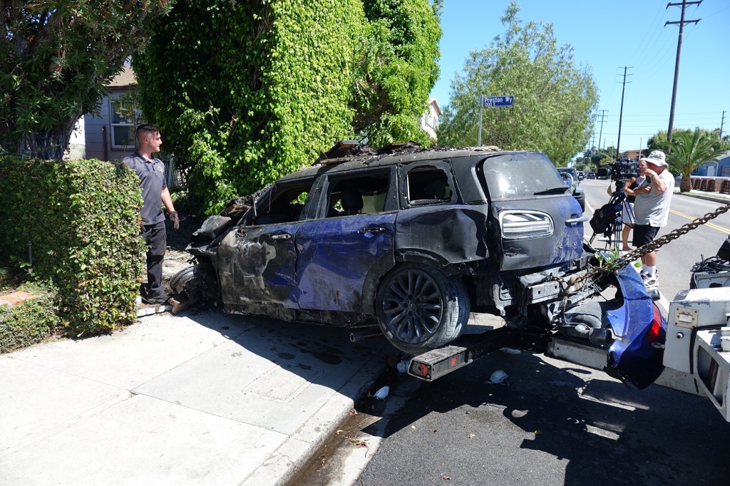 Anne Heche’s wrecked Mini Cooper is towed away from Walgrove Ave in Mar Vista, Los Angeles.