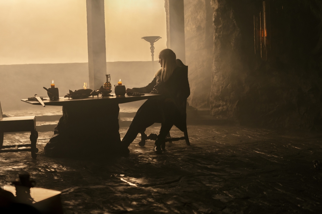 Prince Daemon Targaryen (Matt Smith) sitting alone at a table in silhouette in episode 2 of "House of the Dragon." 