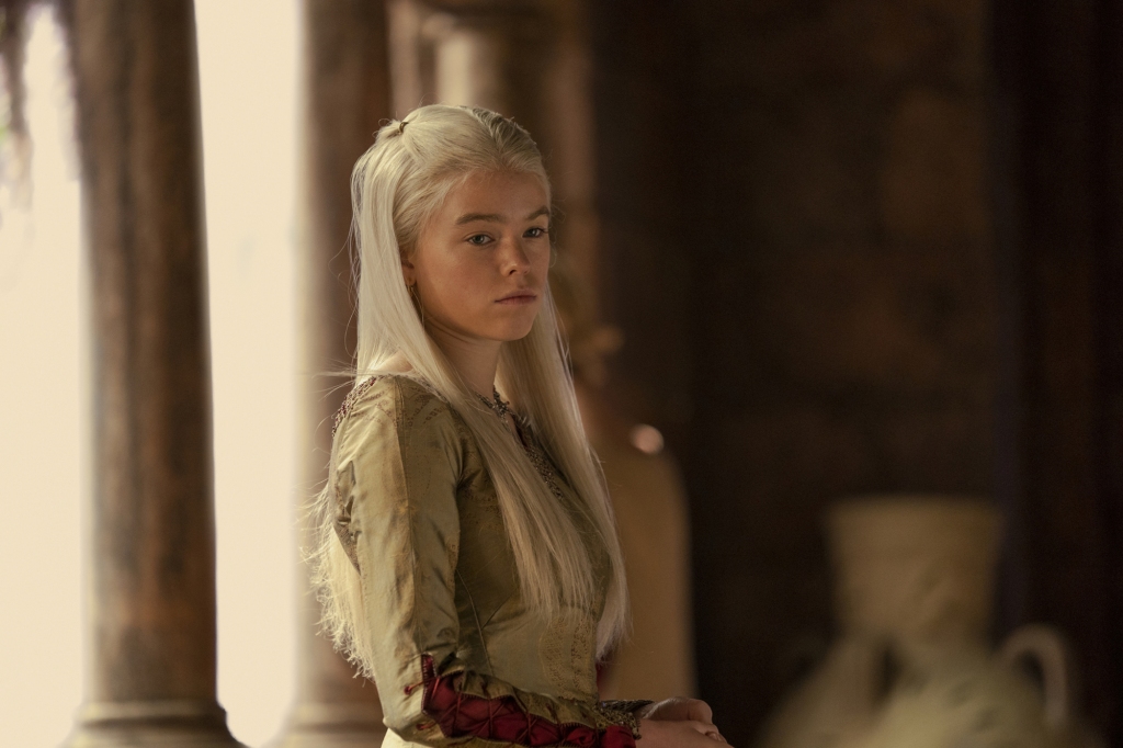 Milly Alcock leaning against a wall looking pensive as Princess Rhaenyra Targaryen in "House of the Dragon." 