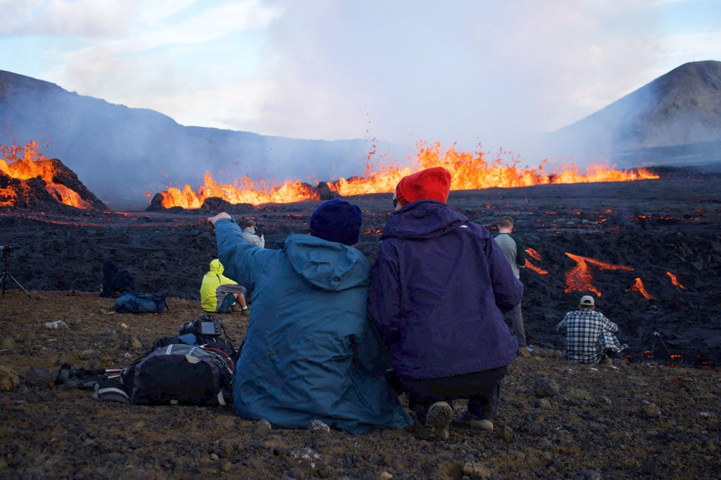 Spectators marvel at lava erupting and flowing in Grindavik, Iceland on August 3, 2022.