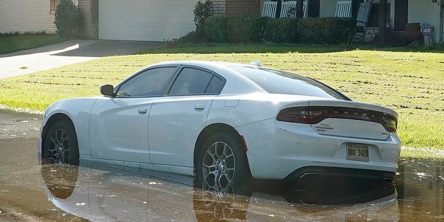 A sedan rests in floodwaters in this northeast Jackson, Miss., neighborhood, Monday, Aug. 29, 2022.