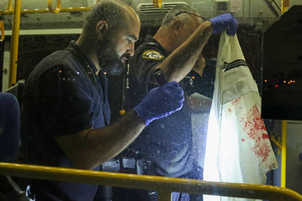 Israeli security inspect a bus after an attack outside Jerusalem's Old City, August 14, 2022.