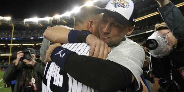 Derek Jeter, #2, and Alex Rodriguez, #13 of the New York Yankees, celebrate on the field after their 7-3 win against the Philadelphia Phillies in Game Six of the 2009 MLB World Series at Yankee Stadium on November 4, 2009 in the Bronx borough of New York City. 