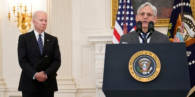 President Joe Biden, left, listens as Attorney General Merrick Garland, right, speaks during an event in the State Dining room of the White House in Washington, Wednesday, June 23, 2021, to discuss gun crime prevention strategy. (AP Photo/Susan Walsh)