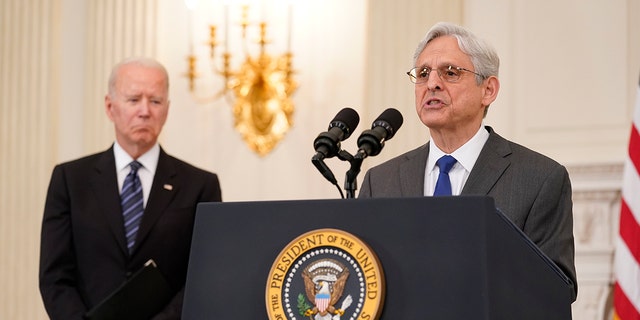 President Joe Biden, left, listens as Attorney General Merrick Garland speaks at the White House on June 23, 2021.