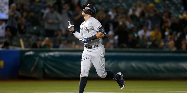 Aaron Judge #99 of the New York Yankees celebrates as he rounds the bases after hitting a three-run home run in the top of the fifth inning against the Oakland Athletics at RingCentral Coliseum on August 26, 2022 in Oakland, California.