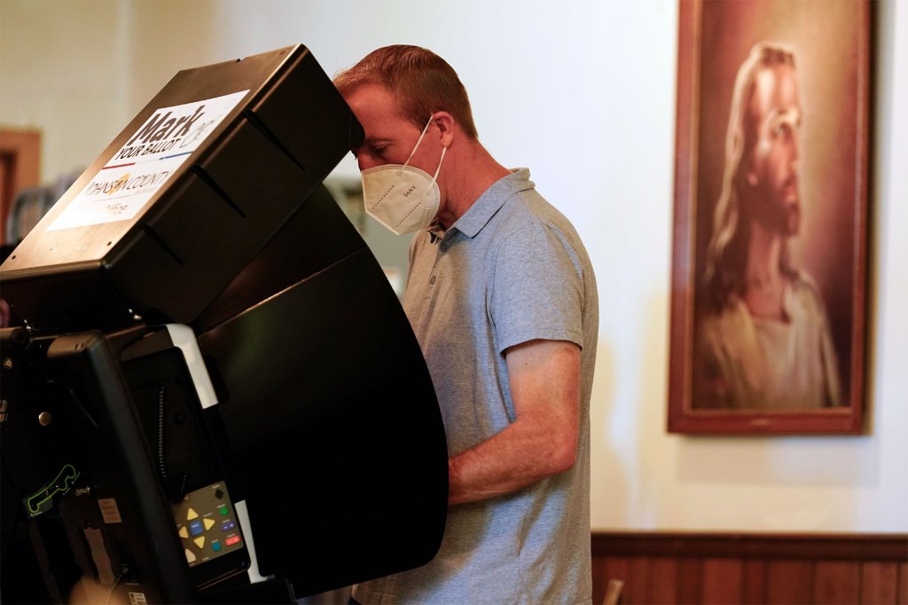 A voter cast their ballot in the Kansas Primary Election at Merriam Christian Church on August 02, 2022.