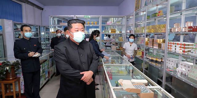 In this photo provided by the North Korean government, North Korean leader Kim Jong Un, center, visits a pharmacy in Pyongyang, North Korea on May 15, 2022. Independent journalists were not given access to cover the event depicted in this image distributed by the North Korean government. The content of this image is as provided and cannot be independently verified. Korean language watermark on image as provided by source reads: "KCNA" which is the abbreviation for Korean Central News Agency.