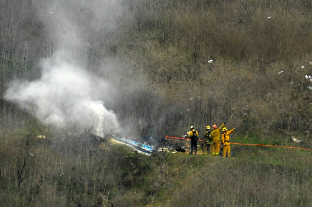 Firefighters work the scene of a helicopter crash where former NBA basketball star Kobe Bryant died in Calabasas, Calif.,