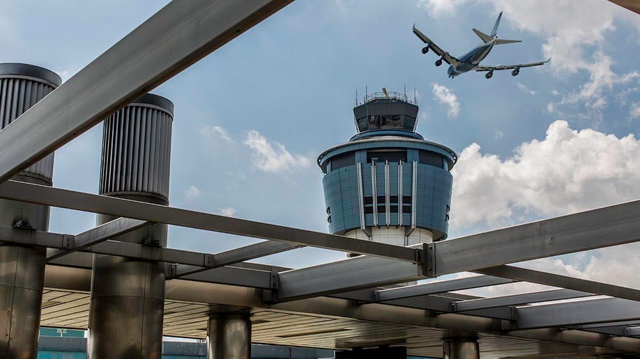 A plane flies over LaGuardia