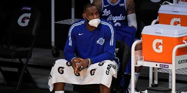 LeBron James of the Los Angeles Lakers wears a face mask on the bench during a game against the Minnesota Timberwolves in Los Angeles on Dec. 27, 2020.