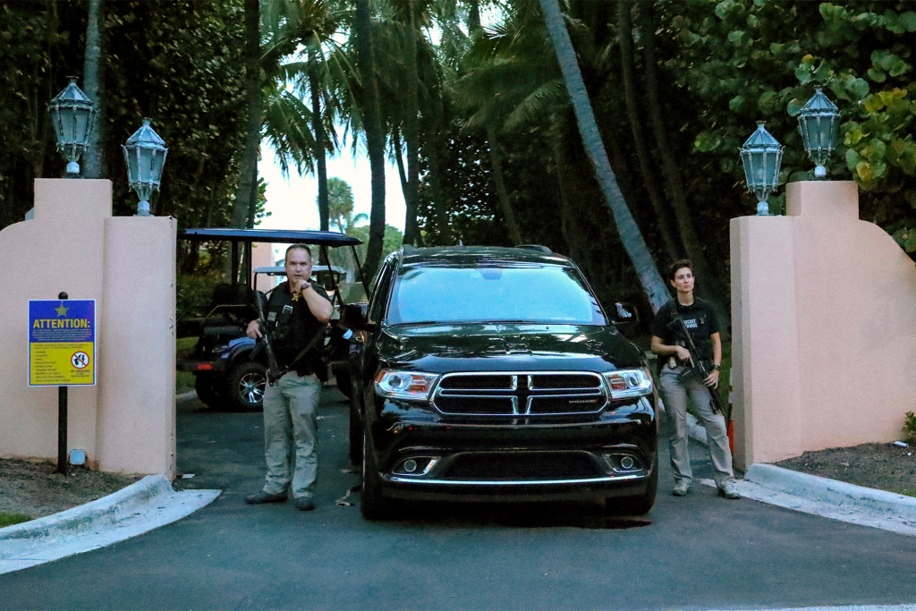 Secret Service agents stand at the gate of Mar-a-Lago after the FBI issued warrants at the Palm Beach, Fla., estate, Monday, Aug. 8, 2020.